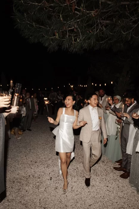Joyful sparkler exit as the newlyweds walk through cheering guests at Conti di San Bonifacio.