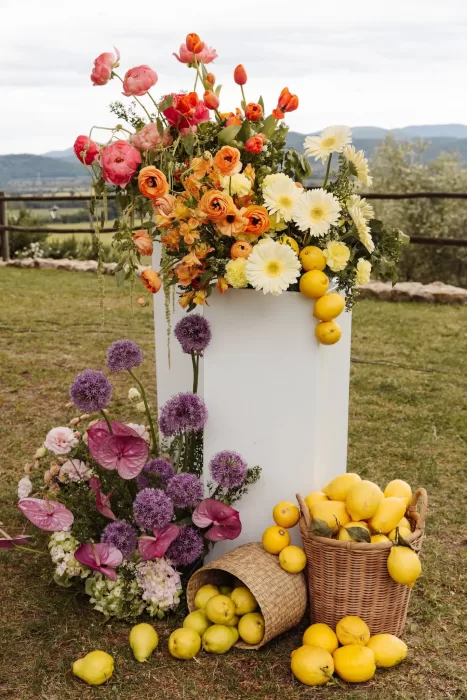Colourful floral arrangements with lemons and pears on the lawn at Conti di San Bonifacio.
