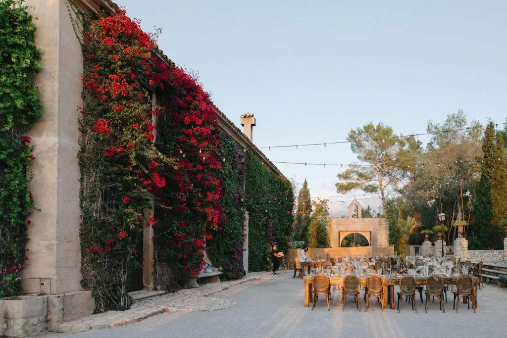 Outdoor dining setup beside a bougainvillea-covered wall at Finca Son Collell