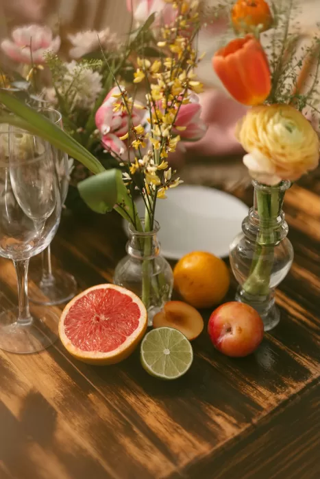 Rustic wedding table decor with fresh citrus, stone fruit, and wildflowers at Finca Son Collell