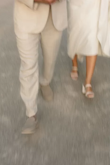 Motion blur shot of bride and groom walking side by side on the gravel path at Finca Son Collell