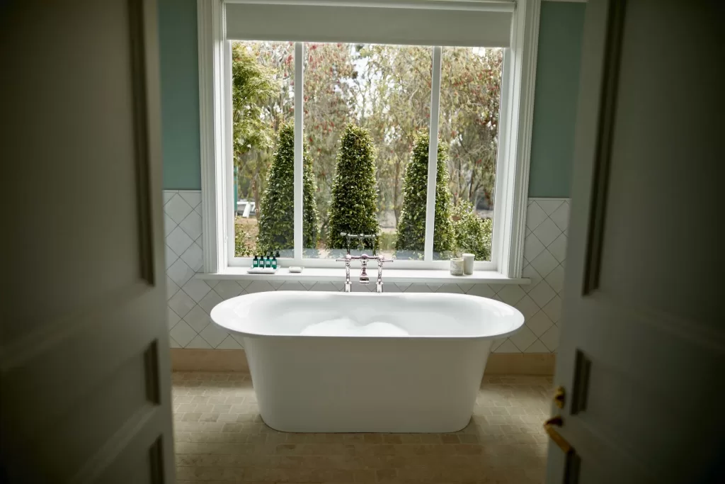 Freestanding bath with garden views in a serene bathroom at Le Mas Barossa