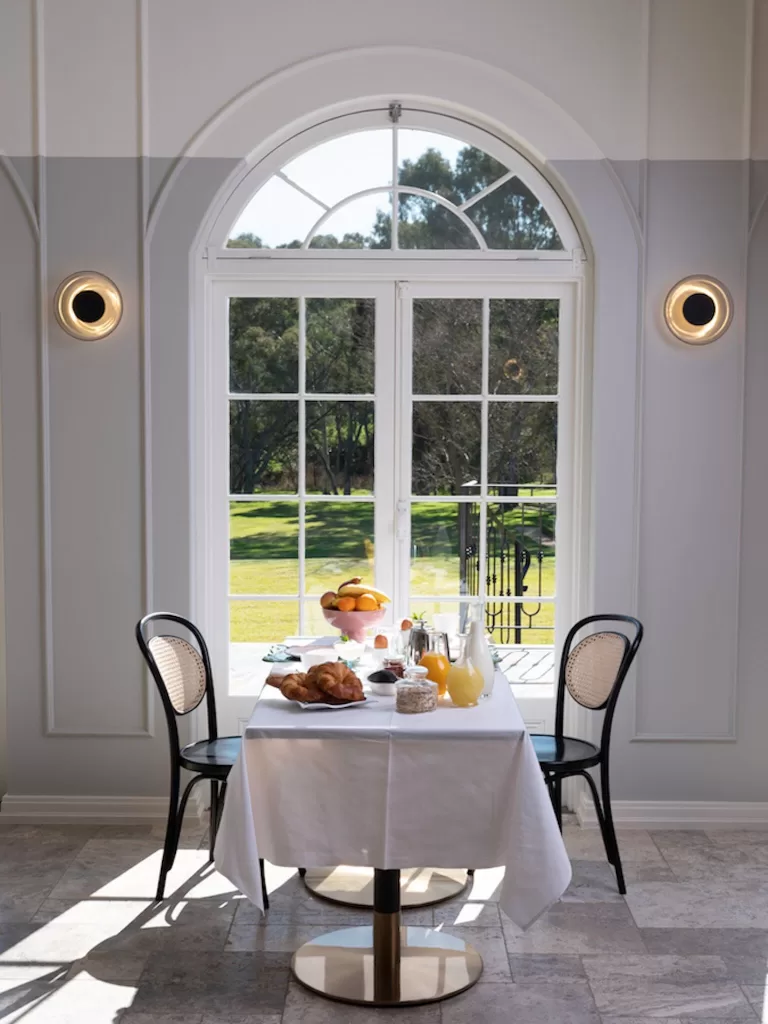 Sunlit breakfast table set for two with croissants and juice at Le Mas Barossa