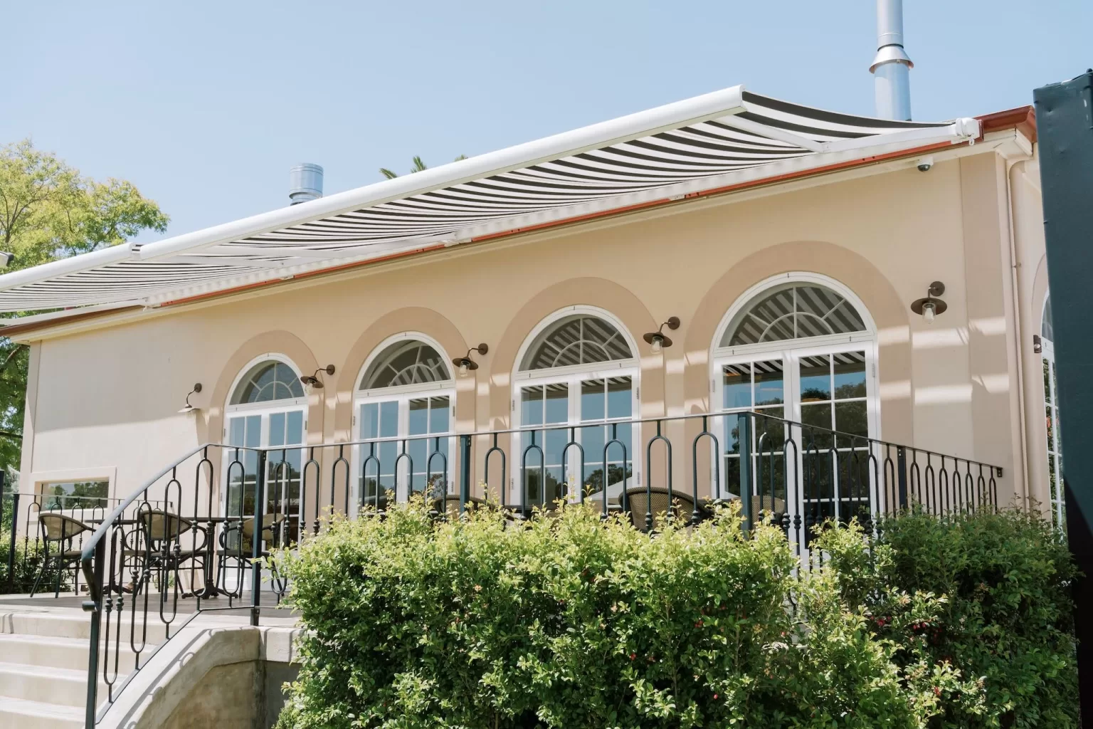 French-style arched doors opening onto a terrace at Le Mas Barossa
