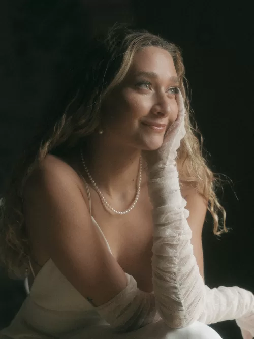 Close-up of smiling bride in pearl necklace and soft natural light at Mas Torroella.