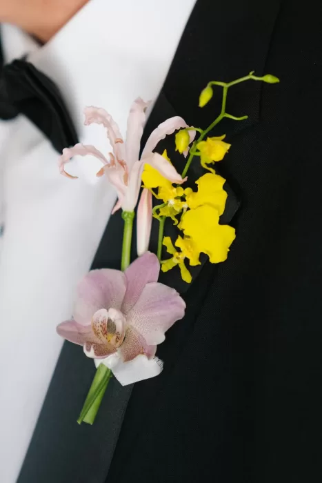 Close-up of the groom’s orchid and oncidium boutonniere at Masia Cabellut