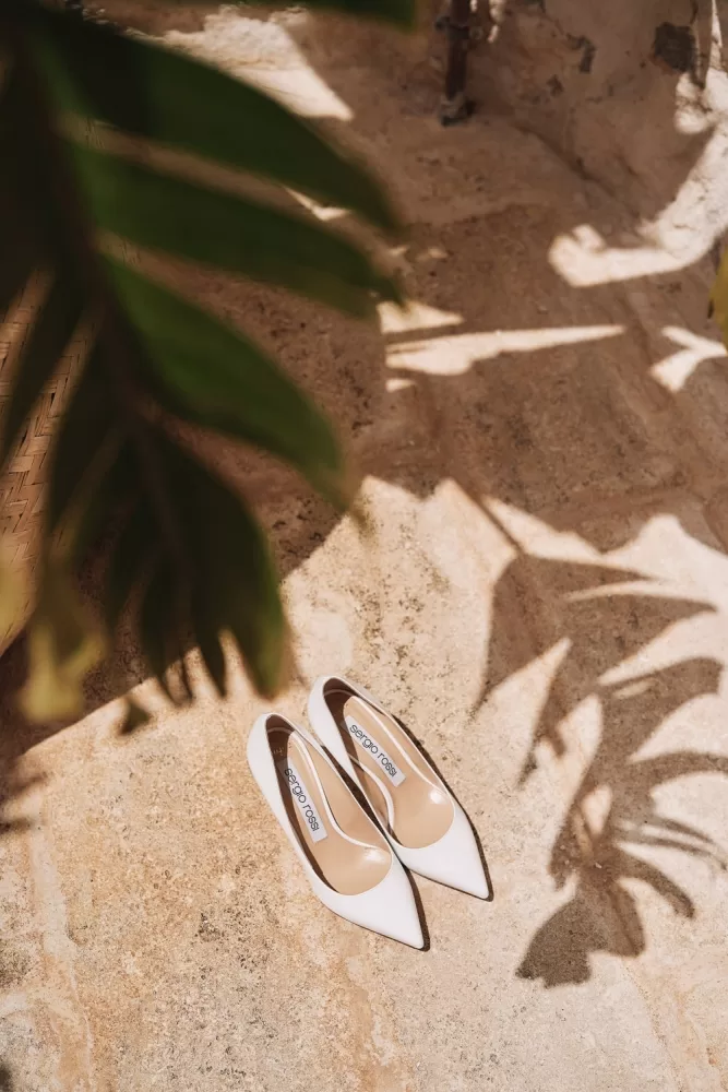 White Sergio Rossi bridal heels in soft natural light at Masseria Calderisi