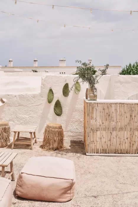 Relaxed boho lounge area with natural textures and whitewashed walls at Masseria Calderisi