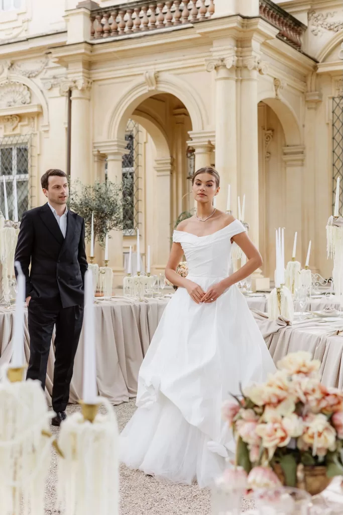 Bride and groom among taupe-draped tables and ivory candles at Villa Aurelia
