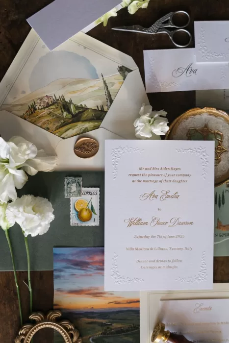 Romantic wedding invitation suite featuring Italian-inspired artwork and white florals, styled at Villa Medicea di Lilliano.