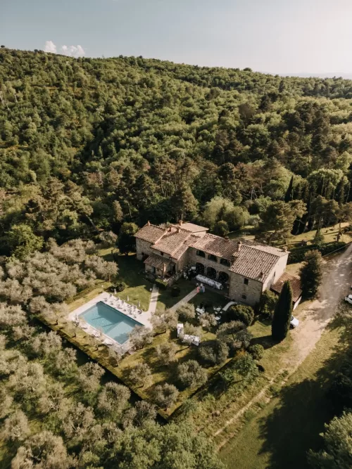 Aerial view of Villa Olimpia nestled in Tuscan countryside with pool and gardens