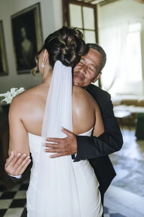 Emotional moment as the bride embraces her father inside Villa Ravano before the ceremony.