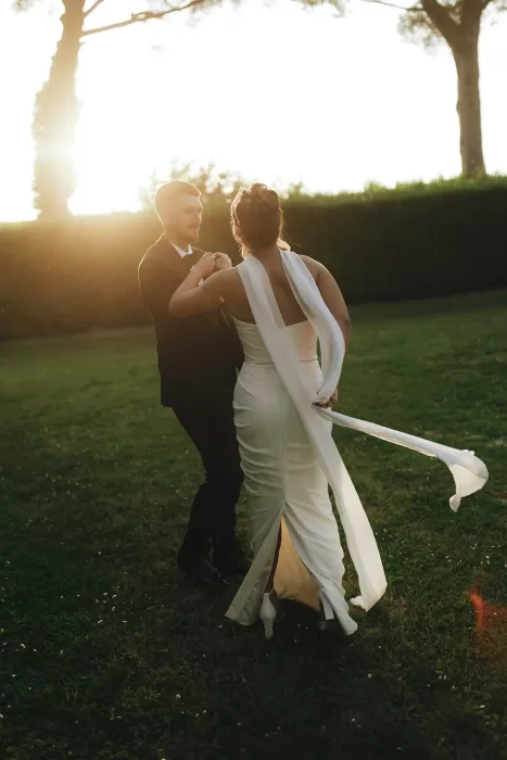 The newlyweds dance on the lawn of Villa Ravano as the golden sun begins to set behind them.