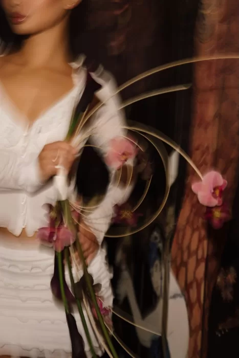 Motion blur photograph of bride’s sculptural bouquet with orchids and calla lilies by Sergey Skripnik.