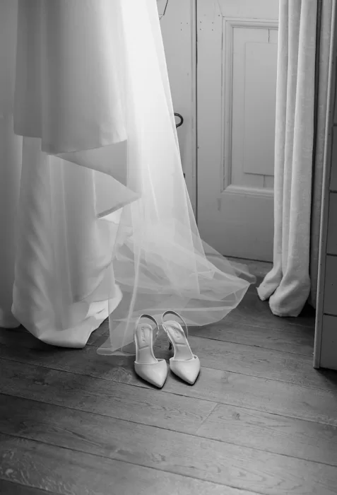 Wedding dress and bridal shoes by the window at Middleton Lodge suite.