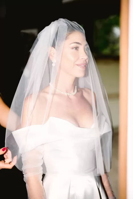 Softly lit portrait of the bride wearing a pearl necklace and veil, moments before her ceremony at Cigarral de la Mercedes.