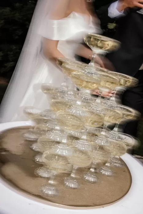 Artistic motion capture of champagne tower being poured by the couple during their celebration at Cigarral de la Mercedes.