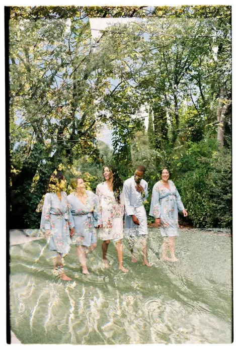 Bridal party in floral robes laughing together at Cigarral de las Mercedes.
