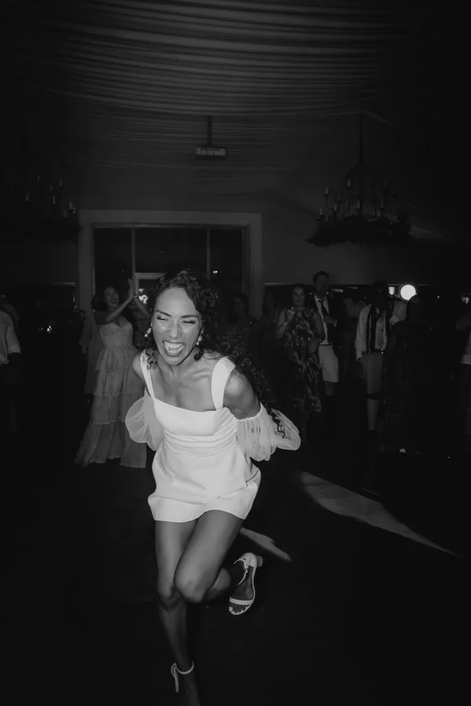 Bride dancing joyfully during the evening celebration at Cigarral de las Mercedes.