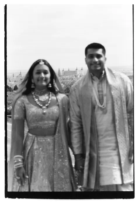 Bride and groom overlooking Toledo skyline, captured on black and white film.