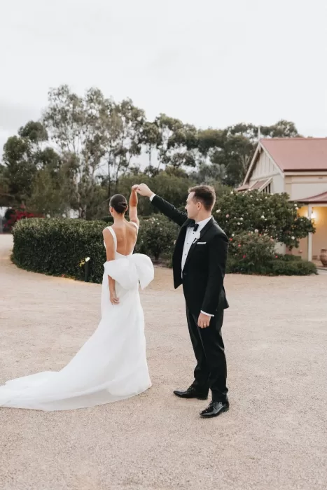 Groom twirling his bride during an intimate dance outside the main house at Le Mas Barossa.