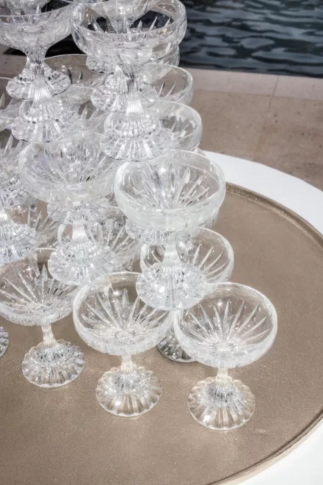 Close-up of stacked crystal coupe glasses sparkling in the sunlight at Cigarral de la Mercedes.