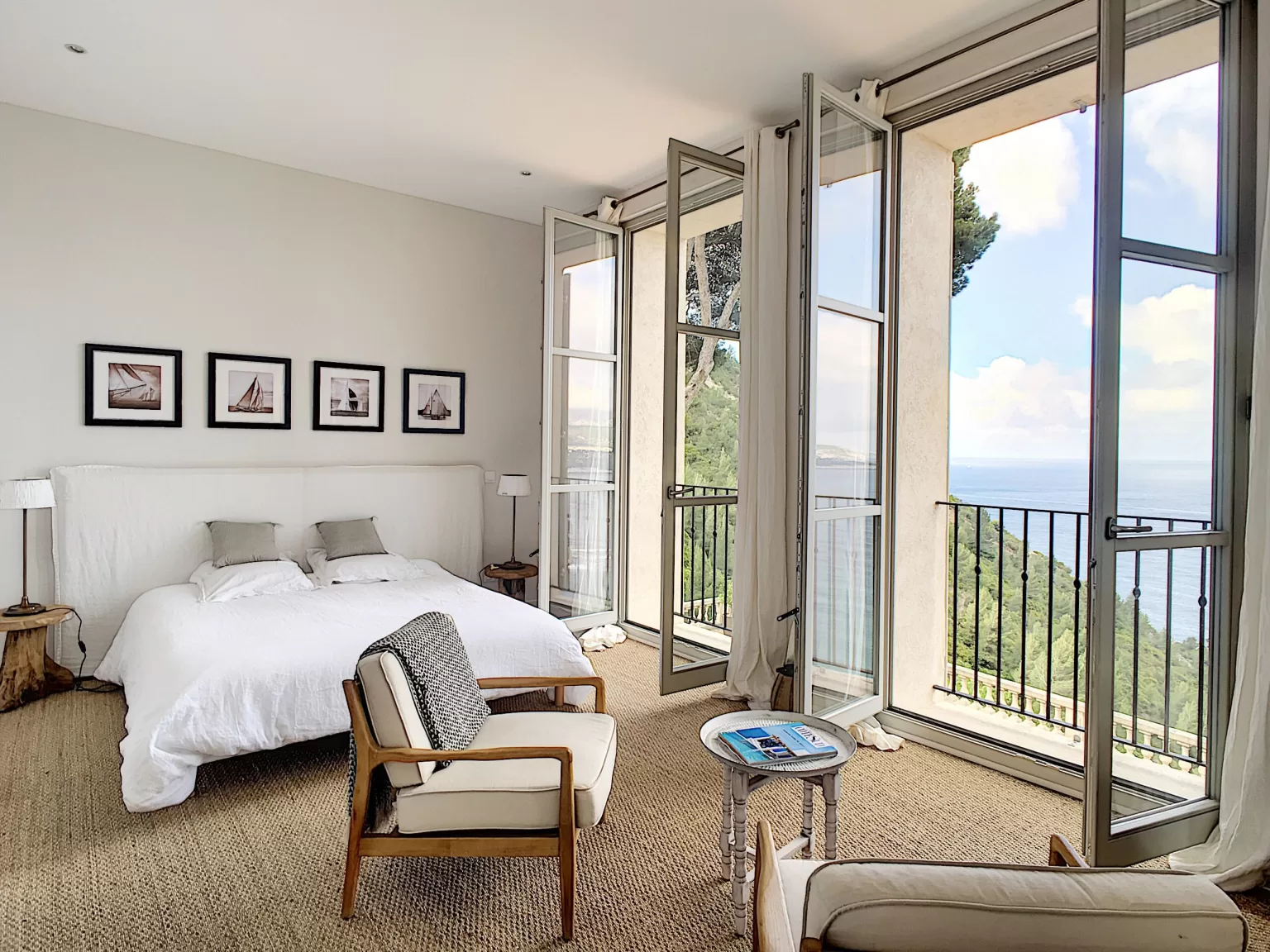 Bright master bedroom at Domaine de Canaille with sea views from French doors.