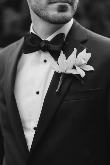 Close-up of the groom’s suit and orchid boutonniere at Graydon Hall.