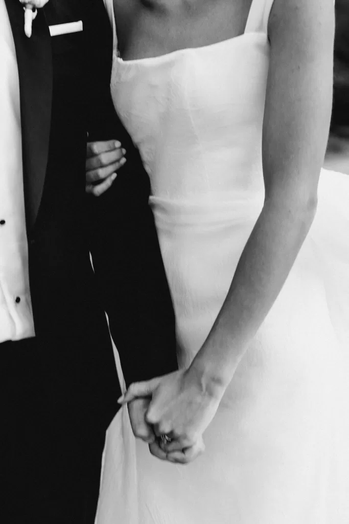 Close-up of bride and groom holding hands, capturing a quiet moment after the ceremony at Le Mas Barossa.