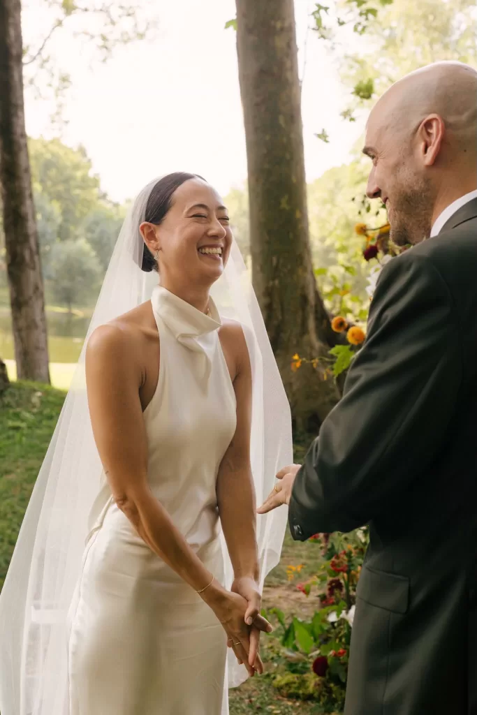 Bride smiling with joy during the outdoor wedding vows at La Farinera de Sant Lluis