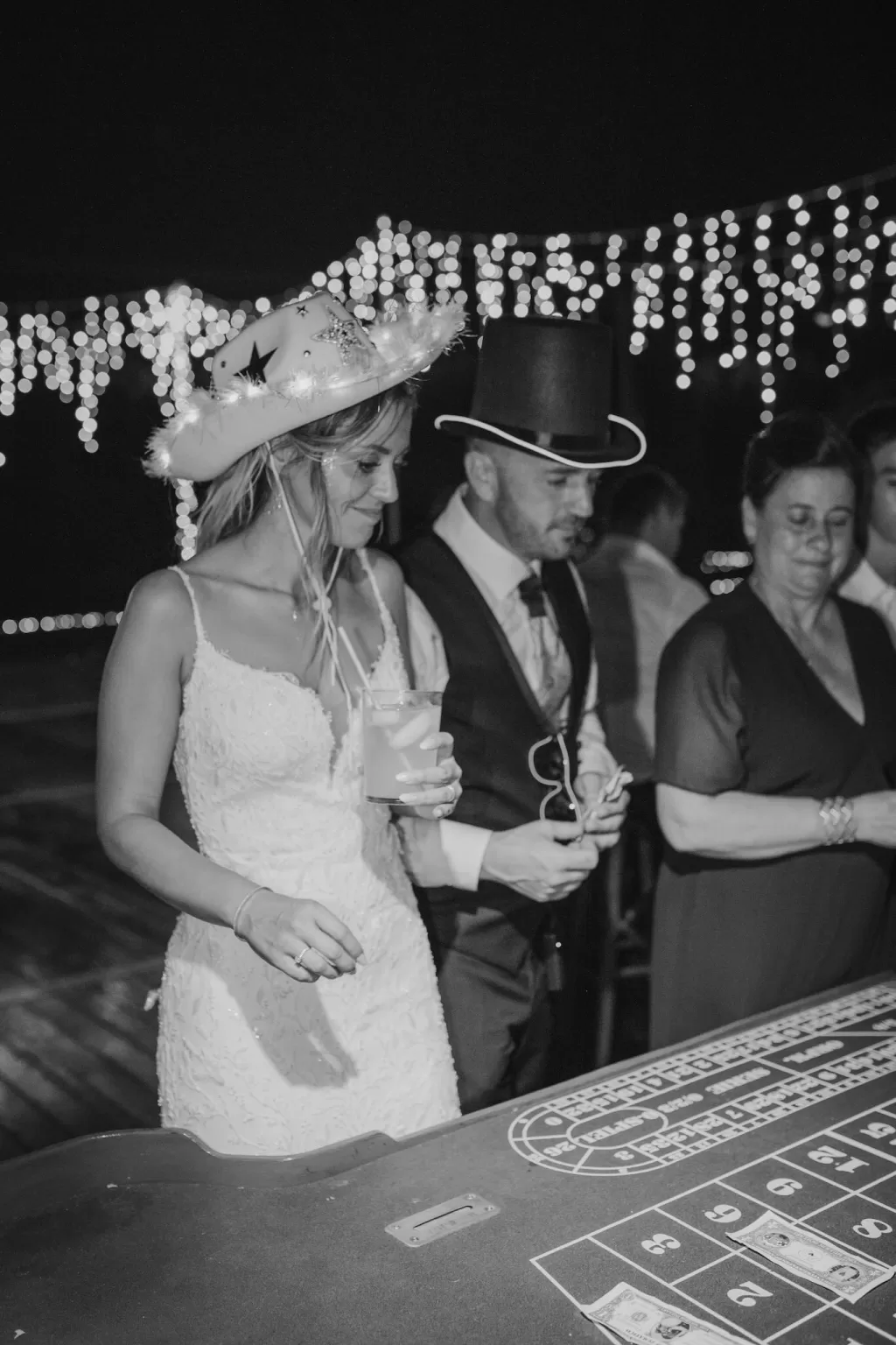 Bride and groom playing casino games at Mas de Les Voltes wedding party.