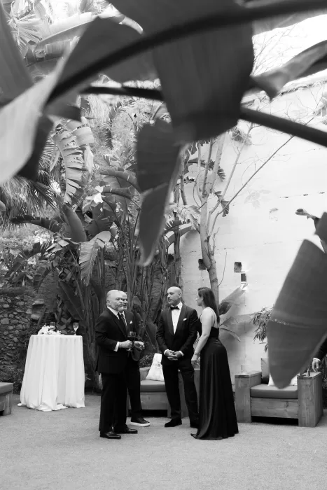 Evening courtyard reception with string lights and banquet tables at Masia Victoria.