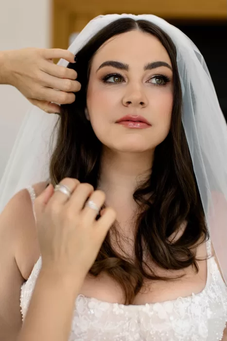 Bride having her veil adjusted before the ceremony at Minos Beach Art Hotel.