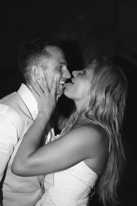 Intimate black and white moment of bride and groom laughing and leaning in close at Museum of Modern Art Dubrovnik.