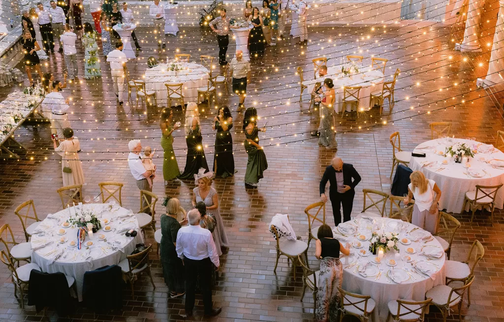 Wedding reception under fairy lights at the Museum of Modern Art Dubrovnik courtyard.