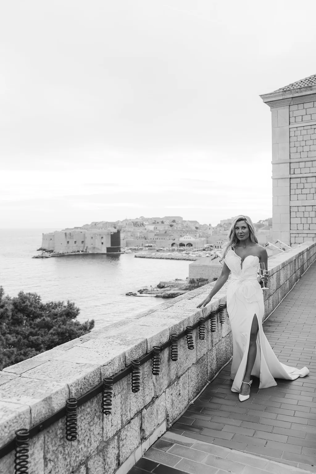 Bride walking along the terrace with Dubrovnik old town in the background at the Museum of Modern Art.