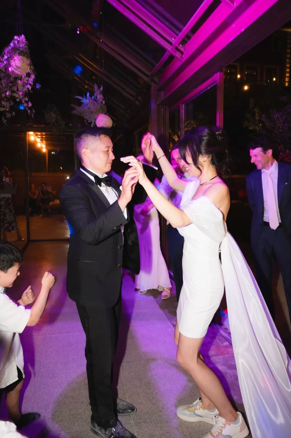 Bride and groom dancing under colorful lights at Six Senses Douro Valley reception.