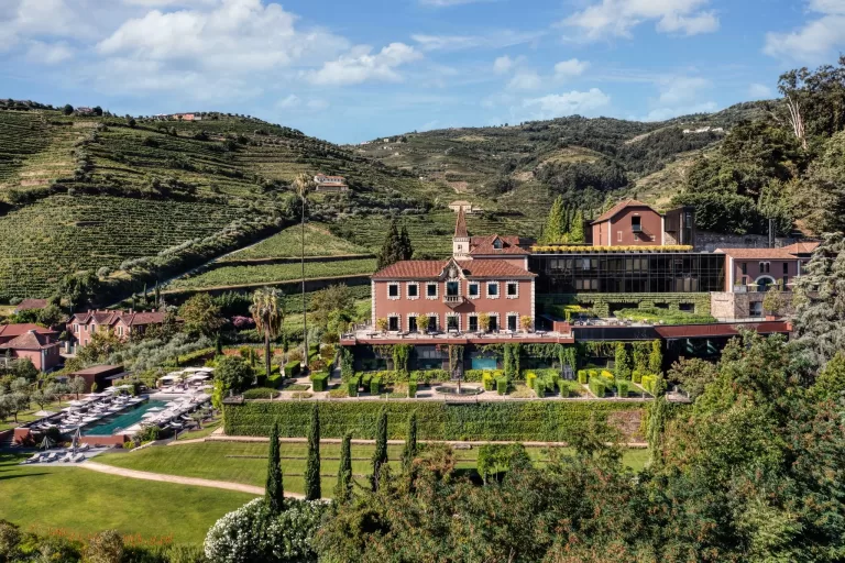Aerial view of the main Six Senses Douro Valley estate set among terraced vineyards.