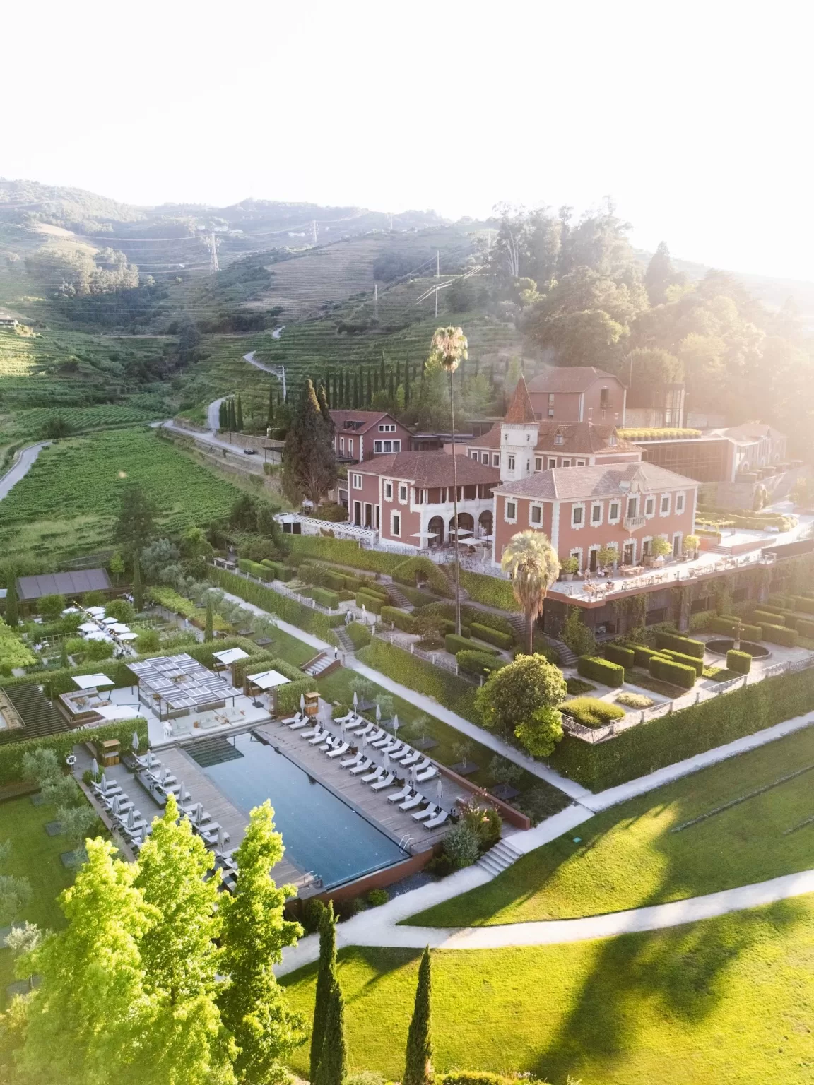 Aerial view of infinity pool and terraced gardens at Six Senses Douro Valley.