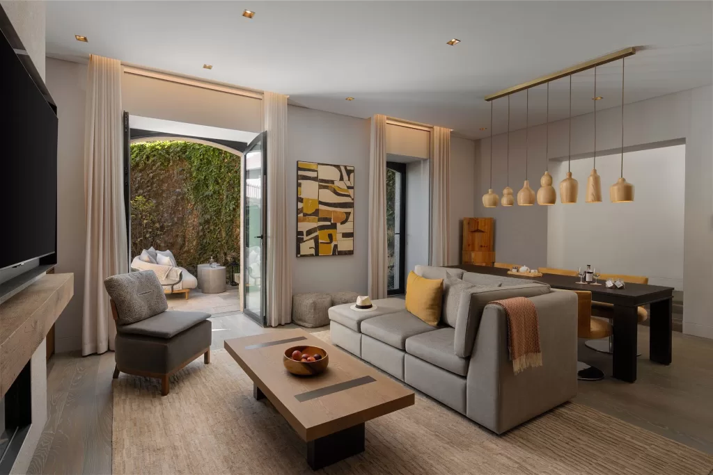 Private suite at Six Senses Douro Valley with cozy seating area opening to ivy-covered courtyard.
