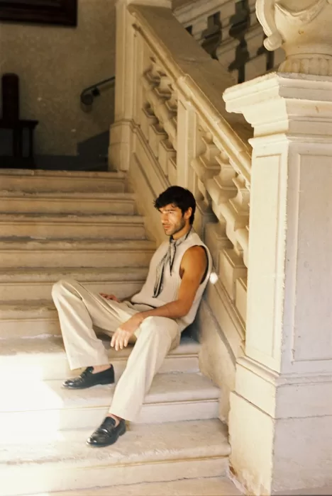 Groom seated on a grand stone staircase inside Villa Arvedi.