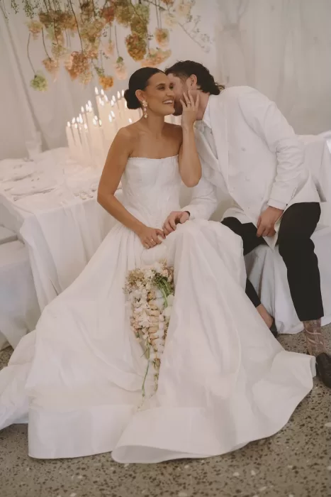 Couple sharing a joyful moment at their Wallalong House wedding reception.
