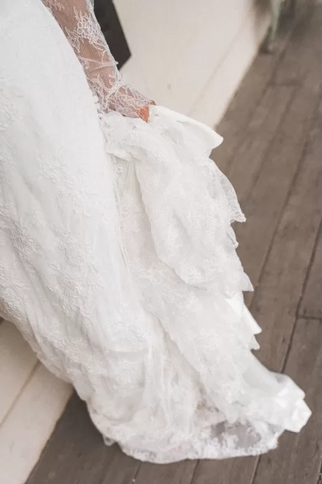 Close-up of a bride holding her lace wedding gown at Wallalong House.