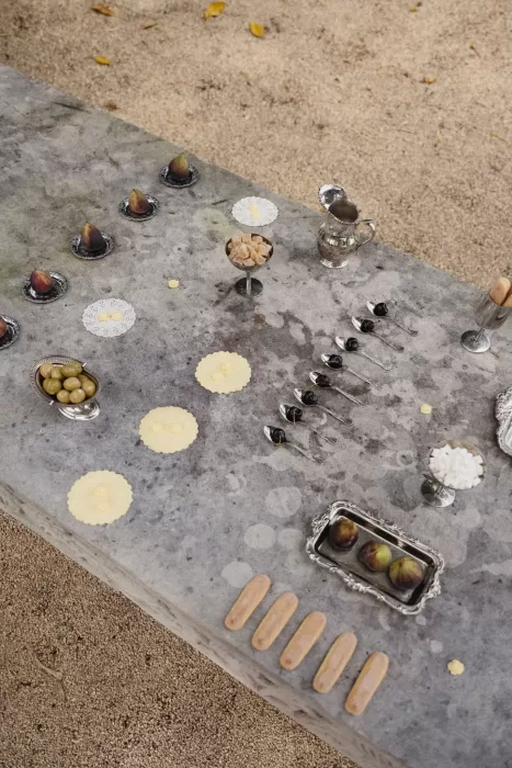 Artistic display of wedding appetizers and desserts on stone table at Wallalong House.