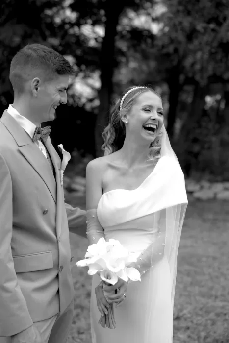Bride laughing joyfully with groom during outdoor celebrations at Winery Hans Igler.