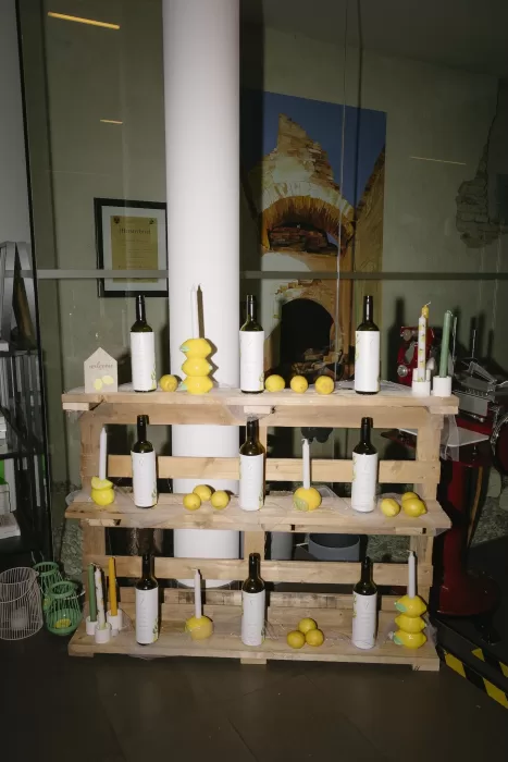 Rustic display of wine bottles, candles, and lemons at Winery Hans Igler wedding.