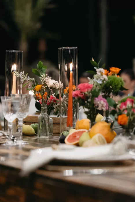Fruit and flower centrepieces with candlelight on rustic tables at Finca Son Collell