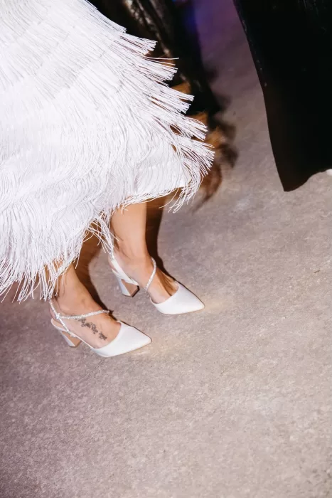 Bride wearing satin heels and fringed dress during the evening party at Finca Son Collell