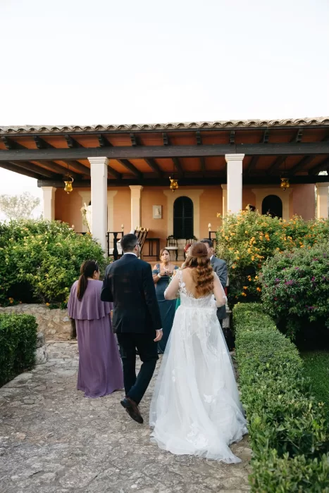 Couple walking through lush gardens after their ceremony at Finca Son Collell