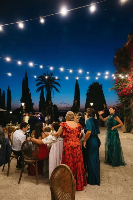 Guests celebrating under festoon lights at Finca Son Collell during a summer evening